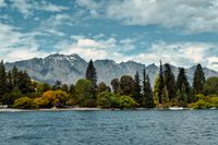 A lake with trees and mountains in the background. A picturesque landscape radiating tranquility and beauty
