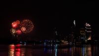 Red fireworks over the skyscrapers of a metropolis