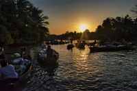 Sunrise at a floating market, people selling fruit and vegetables